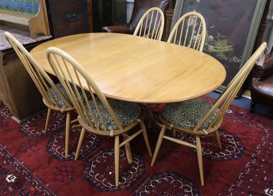 A light oak Ercol table and five chairs W.170cm fully extended